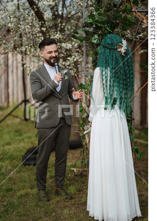 wedding ceremony of the newlyweds in a country cottage 123384366