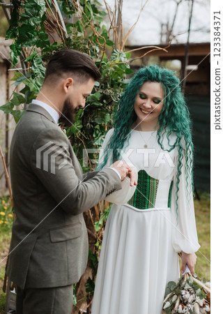 wedding ceremony of the newlyweds in a country cottage 123384371