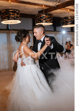 the first dance of the bride and groom inside a restaurant 123385308