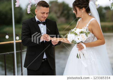 wedding ceremony of the newlyweds on the pier 123385354