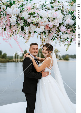wedding ceremony of the newlyweds on the pier 123385411