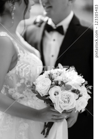 the groom in a brown suit and the bride in a white dress 123385483