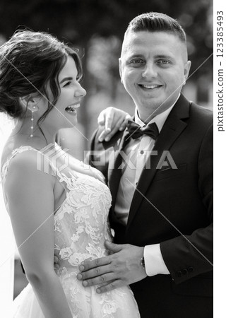 the groom in a brown suit and the bride in a white dress the groom in a brown suit and the bride in a white dress 123385493