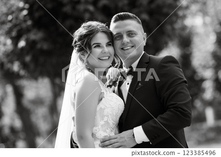 the groom in a brown suit and the bride in a white dress the groom in a brown suit and the bride in a white dress 123385496