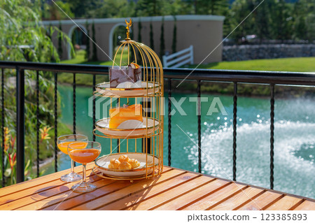 Afternoon tea set, orange juice, English style, dessert set, near the pool. Afternoon tea set, orange juice, English style, dessert set, near the pool. 123385893