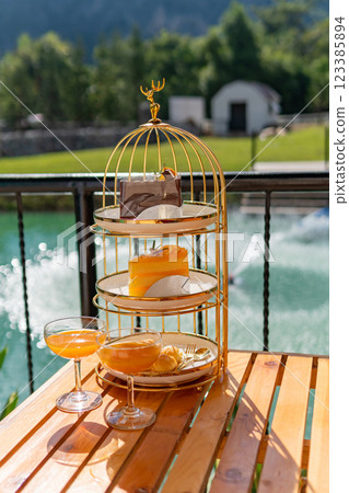 Afternoon tea set, orange juice, English style, dessert set, near the pool. 123385894