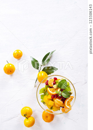 Sweet mandarins and green leaves on light background Sweet mandarins and green leaves on light background 123386143