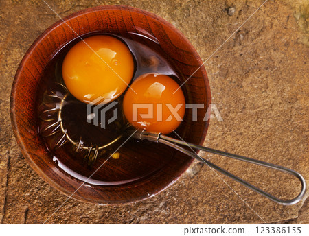 raw chicken eggs in bowl on stone board 123386155