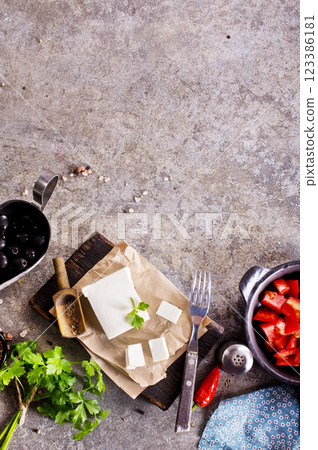 ingredients for salad, tomatoes, feta, olives and Basil, serving on a light background, tatsy food ingredients for salad, tomatoes, feta, olives and Basil, serving on a light background, tatsy food 123386181