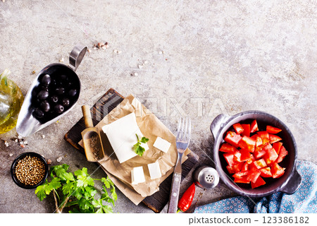 ingredients for salad, tomatoes, feta, olives and Basil, serving on a light background, tatsy food 123386182