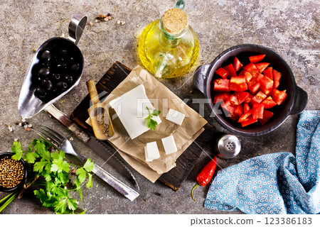 ingredients for salad, tomatoes, feta, olives and Basil, serving on a light background, tatsy food 123386183