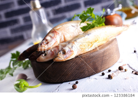 Fresh fish and spice on white table 123386184