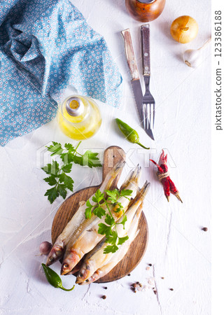 Fresh fish and spice on white table Fresh fish and spice on white table 123386188