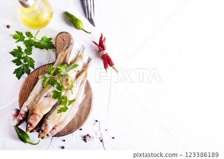 Fresh fish and spice on white table 123386189
