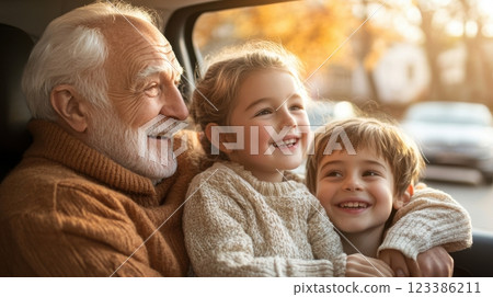 Joyful family moments in autumn with grandfather and grandchildren. Automotive battery Joyful family moments in autumn with grandfather and grandchildren. Automotive battery 123386211