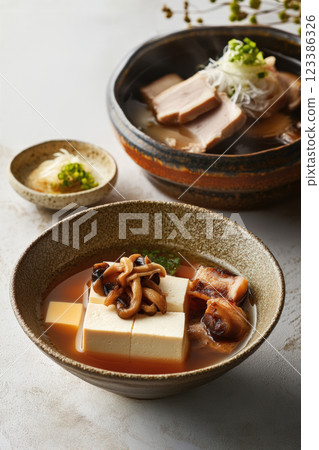 Japanese tofu soup with mushrooms and pork 123386326