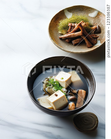 Japanese tofu soup with mushrooms and greens 123386387