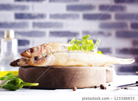 Fresh fish and spice on white table Fresh fish and spice on white table 123386655