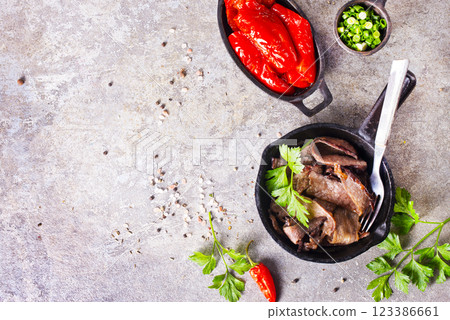 Grilled or pan fried pork chops on the bone with garlic and fresh greens Grilled or pan fried pork chops on the bone with garlic and fresh greens 123386661