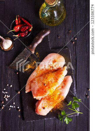 Raw fresh chicken fillet on black stone board 123386774
