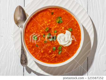 Red Lentil Tomato Soup with sour cream in a bowl 123387152