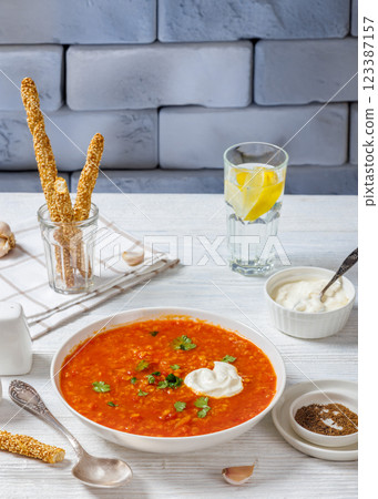 Red Lentil Tomato Soup with sour cream in a bowl Red Lentil Tomato Soup with sour cream in a bowl 123387157