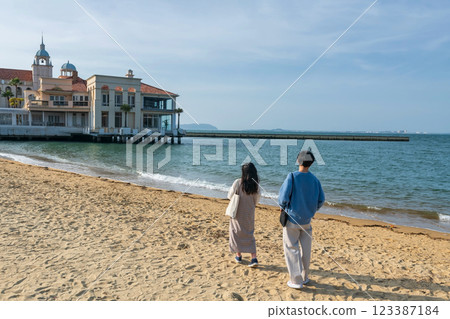 Couple on beach at Marizon hall at Momochi Seaside Park, Fukuoka 123387184