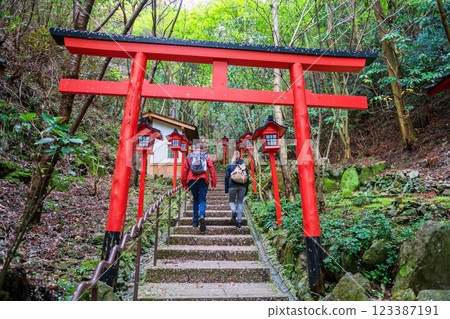 Tourist couple walk though torii gate at Nanzoin temple, Fukuoka Tourist couple walk though torii gate at Nanzoin temple, Fukuoka 123387191