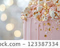 Close-up of elegant pink cake with gold accents 123387334