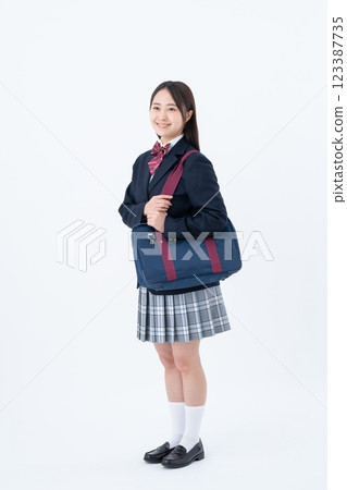 Smiling high school girl with a school bag 123387735