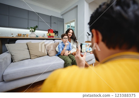 Family captures a joyful moment together in a bright living room 123388375