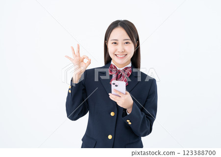 High school girl using smartphone High school girl using smartphone 123388700