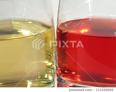 Red and white wine in transparent glasses over white background Red and white wine in transparent glasses over white background 123389008