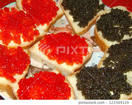 Red and black caviar over red background Red and black caviar over red background 123389120