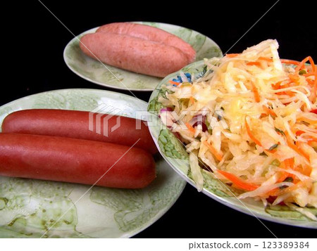 Sausage and salad on plates background 123389384