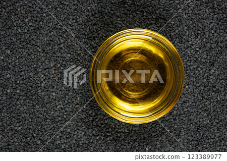 Unrefined cold pressed sesame oil in a glass bowl. Unrefined cold pressed sesame oil in a glass bowl. 123389977