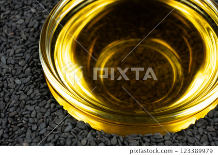Unrefined cold pressed sesame oil in a glass bowl. Unrefined cold pressed sesame oil in a glass bowl. 123389979