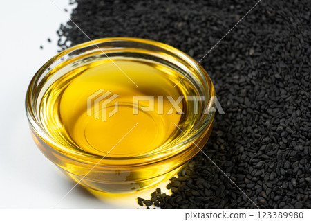 Unrefined cold pressed sesame oil in a glass bowl. Unrefined cold pressed sesame oil in a glass bowl. 123389980