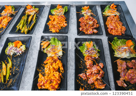 assortment of meat and various Asian dishes at buffet in the hotel restaurant in Asia in Vietnam assortment of meat and various Asian dishes at buffet in the hotel restaurant in Asia in Vietnam 123390451