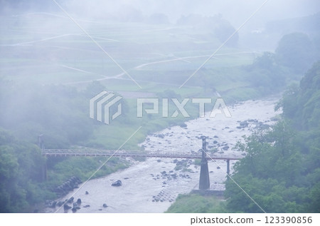 The Chikuma River and Ohikui Bridge as seen from Komoro Ohashi Bridge during the rainy season 123390856
