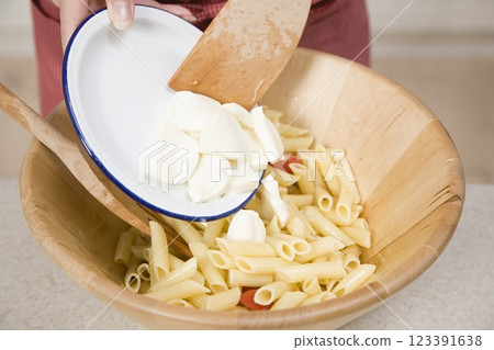 Adding Mozzarella to Pasta, Food Photography, Close View Background Adding Mozzarella to Pasta, Food Photography, Close View Background 123391638