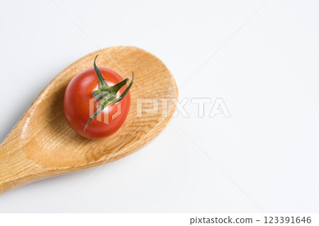 Tomato on a Wooden Spoon, Close View Background Tomato on a Wooden Spoon, Close View Background 123391646