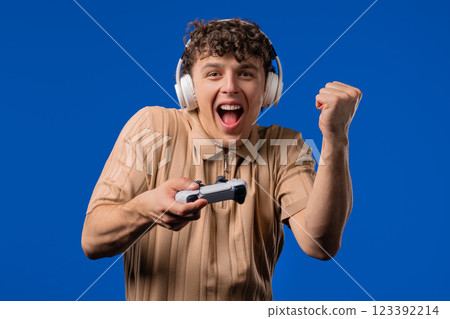 Young adult man playing online video game on console TV with joystick. e-sport 123392214