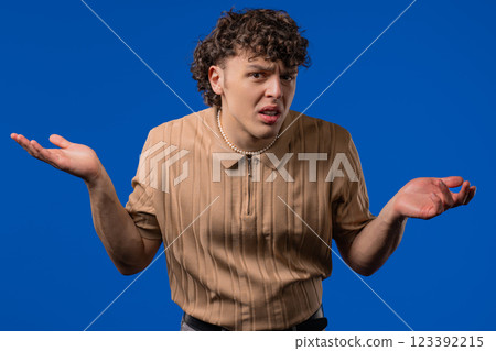 Confused man, shoulders up - can't help, makes gesture I dont know. Indifferent guy, ignorance concept. Confused man, shoulders up - can't help, makes gesture I dont know. Indifferent guy, ignorance concept. 123392215