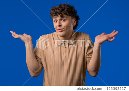 Ignorant mature 30s man, shoulders up - can't help, makes gesture I dont know 123392217