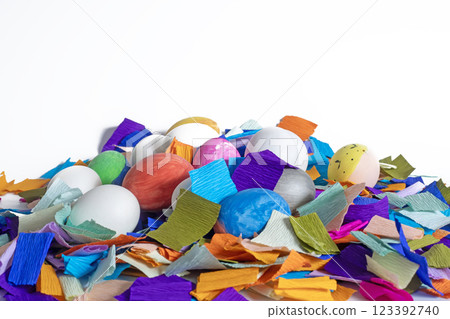 Brightly colored Easter eggs in vibrant paper confetti on a white background. Brightly colored Easter eggs in vibrant paper confetti on a white background. 123392740