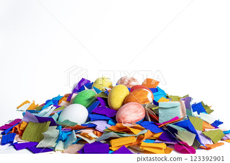 Colorful Easter eggs amidst festive paper decorations on a white background 123392901
