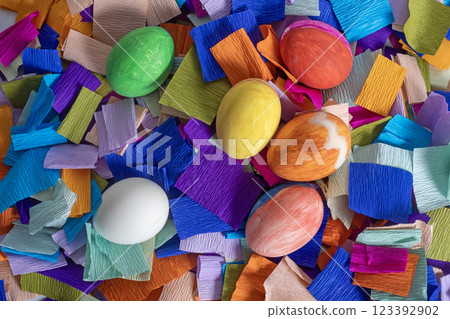 Colorful Easter eggs on a background of bright crepe paper strips 123392902