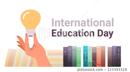 human hand holding light lamp near books new idea innovation international education day concept horizontal human hand holding light lamp near books new idea innovation international education day concept horizontal 123393328