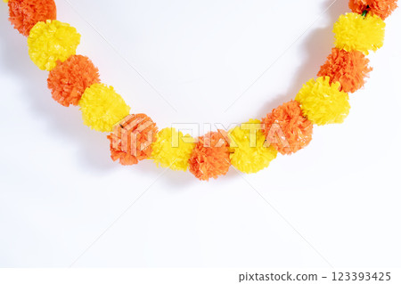 Colorful artificial marigold flower garland for festive and decorative celebrations. 123393425